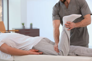 Physiotherapist working with patient in clinic