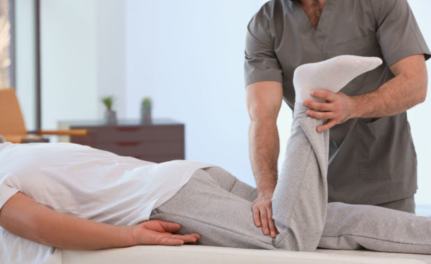 Physiotherapist working with patient in clinic