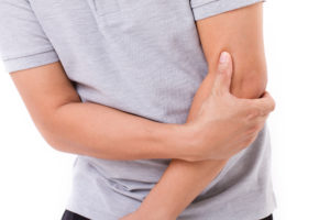 man suffering from elbow joint pain
