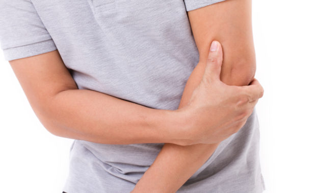 man suffering from elbow joint pain